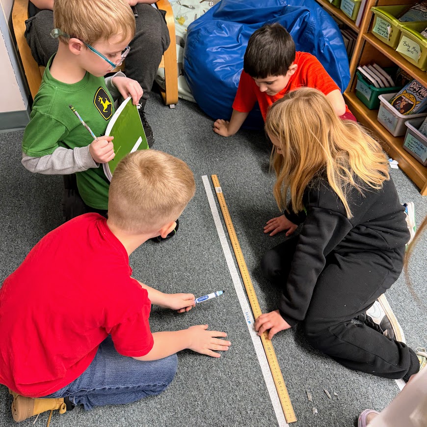 Students measuring with a meter stick